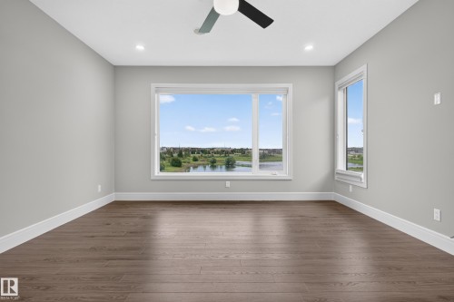 Recessed lighting and a ceiling fan illuminate this space featuring wood-finish flooring - 2219 22 Street Nw, Edmonton, AB 