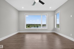 Recessed lighting and a ceiling fan illuminate this space featuring wood-finish flooring - 