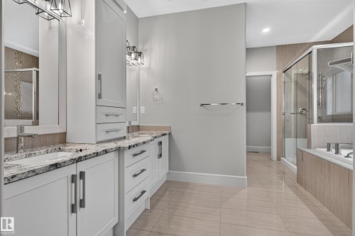 Dual white vanities with integrated sinks and granite countertops - 2219 22 Street Nw, Edmonton, AB 