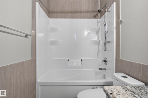 White tub and shower combination with chrome fixtures - 2219 22 Street Nw, Edmonton, AB 