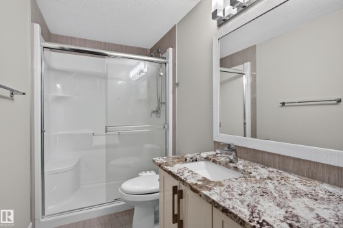 Walk-in shower with clear glass enclosure and built-in seating - 2219 22 Street Nw, Edmonton, AB 