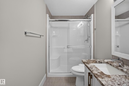 Shower with sliding glass enclosure, integrated bench, and chrome fixtures - 2219 22 Street Nw, Edmonton, AB 
