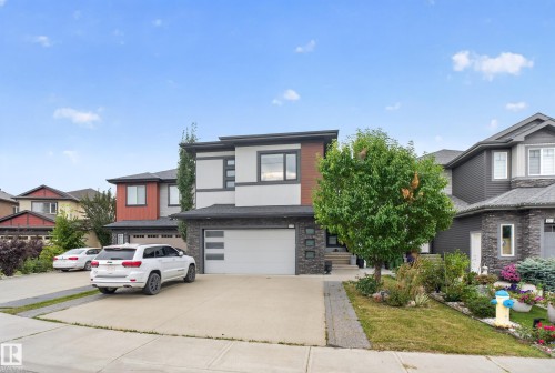Contemporary exterior design featuring a stone facade and wood-finish accents - 2219 22 Street Nw, Edmonton, AB 