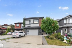 Contemporary exterior design featuring a stone facade and wood-finish accents - 