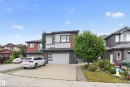 Contemporary exterior design featuring a stone facade and wood-finish accents - 2219 22 Street Nw, Edmonton, AB 