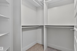 Custom closet system featuring multiple hanging rods and integrated shelving - 