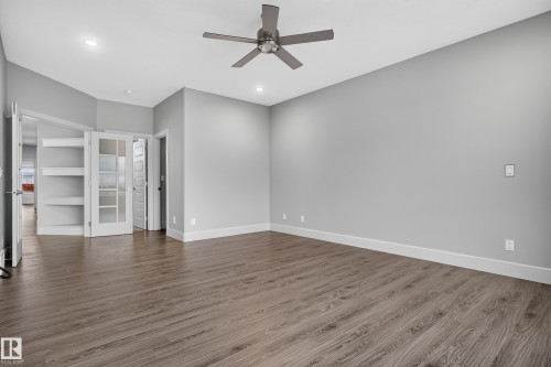 Wood-finish flooring with white trim, recessed ceiling lighting, and a ceiling fan - 2219 22 Street Nw, Edmonton, AB 