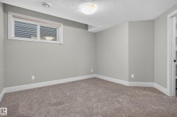 Neutral-toned walls, plush carpet flooring, a window with blinds, and recessed lighting - 