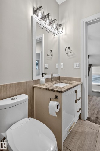 Vanity with a granite countertop, undermount sink, and chrome faucet - 2219 22 Street Nw, Edmonton, AB 