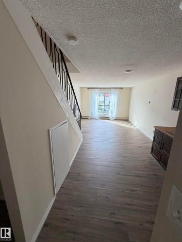 Wood-finish flooring throughout the main level - #209 11429 124 St Nw, Edmonton, AB 