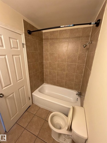 Tiled flooring complementing the shower surround - #209 11429 124 St Nw, Edmonton, AB 
