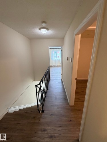 Wood-finish flooring throughout the hallway - #209 11429 124 St Nw, Edmonton, AB 