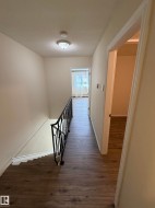 Wood-finish flooring throughout the hallway - 