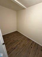 Wood-finish flooring, neutral wall tones, and recessed ceiling lighting - 