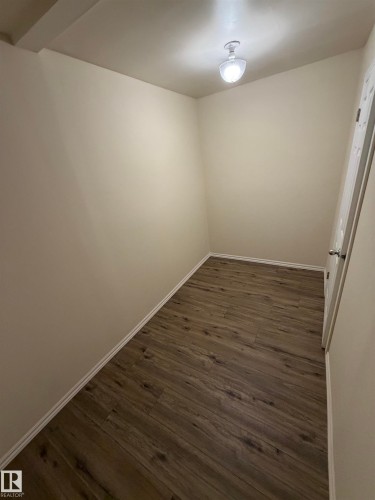 Wood-finish flooring with white trim - #209 11429 124 St Nw, Edmonton, AB 