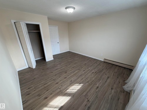 Wood-finish flooring, neutral wall tones, and overhead lighting - #209 11429 124 St Nw, Edmonton, AB 