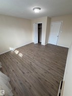 Wood-finish flooring throughout, neutral wall tones, and a built-in closet with bi-fold doors - 
