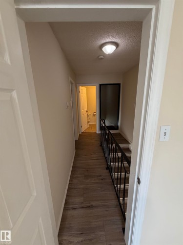 Wood-finish flooring throughout the hallway - #209 11429 124 St Nw, Edmonton, AB 