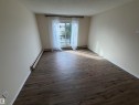 Wood-finish flooring throughout, neutral wall color, and a sliding glass door with a transom window - #209 11429 124 St Nw, Edmonton, AB 