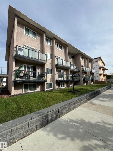 Multi-story building with textured stucco exterior - #209 11429 124 St Nw, Edmonton, AB 