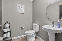 Pedestal sink with chrome faucet and circular mirror - 