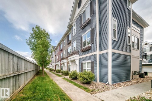 Multi-story facades with horizontal siding and contrasting trim - #20 8315 180 Av Nw, Edmonton, AB 