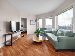 Hardwood-finish flooring, expansive windows, light-toned walls, and white trim - 
