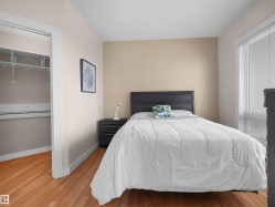 Hardwood flooring, painted walls, window with blinds, closet with wire shelving - 