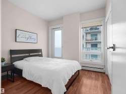 Wood-finish flooring, white walls, and a window with blinds - 