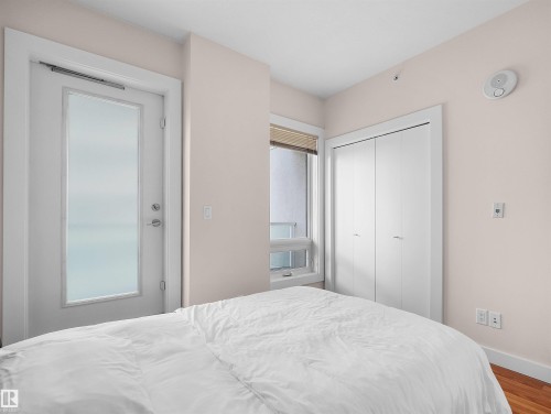 Frosted glass-panel door, built-in closet, and light wood-finish flooring - #1601 10136 104 St Nw, Edmonton, AB 