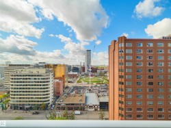 Cityscape with diverse architectural styles, including a prominent high-rise structure - 