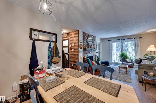 Dining area with overhead geometric pendant lighting - #203 24 Alpine Pl, St. Albert, AB 