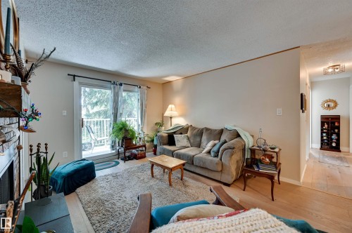 Fireplace with brick surround, wood mantel, and hearth - #203 24 Alpine Pl, St. Albert, AB 