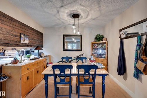 Recessed lighting, wood-finish flooring, and a contemporary pendant light fixture - #203 24 Alpine Pl, St. Albert, AB 