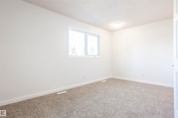 Bright room with light-toned carpet, a double window, and a flush-mount ceiling light fixture - 
