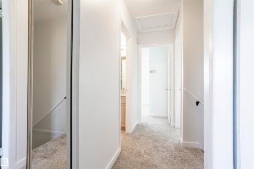 Hallway with light gray carpet flooring, white walls, and white trim - 17927 80 Avenue Nw, Edmonton, AB 