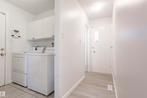 White cabinetry, light-toned flooring, and a white entry door with an inset window - 17927 80 Avenue Nw, Edmonton, AB 