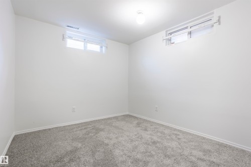 Neutral wall finishes, recessed windows, overhead ceiling fixture, and grey carpeting - 17927 80 Avenue Nw, Edmonton, AB 