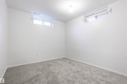 Neutral wall finishes, recessed windows, overhead ceiling fixture, and grey carpeting - 