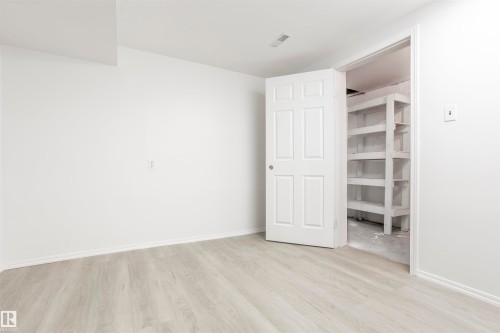 Light wood-finish flooring with white walls and trim - 17927 80 Avenue Nw, Edmonton, AB 