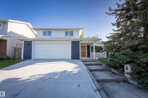 Contemporary exterior with a two-car garage, concrete driveway, and covered entry - 17927 80 Avenue Nw, Edmonton, AB 