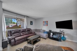 Living area featuring light wood-finish flooring and a large window - 
