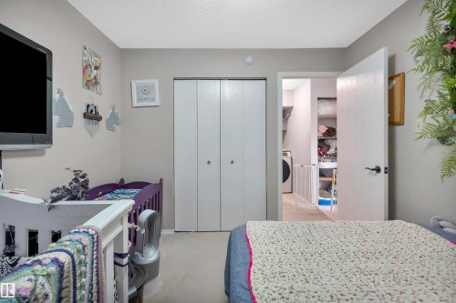 Neutral-toned walls with textured ceiling - 15017 26 Street Nw, Edmonton, AB 