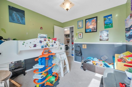 Recessed ceiling light fixture, wall-mounted artwork, interior door leading to an additional space, carpeted flooring, two-tone painted walls - 15017 26 Street Nw, Edmonton, AB 