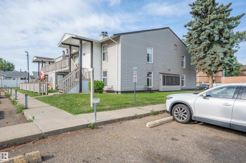 Two-story exterior with light gray siding and white trim - 15017 26 Street Nw, Edmonton, AB 