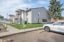 Two-story exterior with light gray siding and white trim - 15017 26 Street Nw, Edmonton, AB 