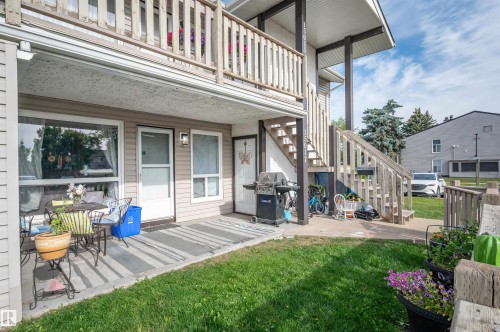 Ground-level patio with concrete slab and direct outdoor access - 15017 26 Street Nw, Edmonton, AB 
