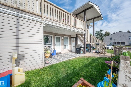 Two-story structure with siding exterior and a wooden balcony with railing - 15017 26 Street Nw, Edmonton, AB 