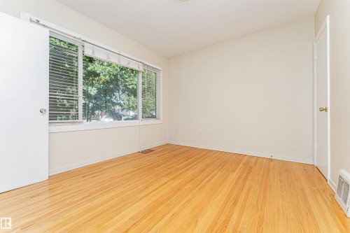 Hardwood flooring and multiple windows with blinds - 8743 Strathearn Drive Nw, Edmonton, AB 