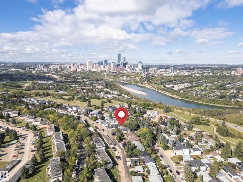 Residential street with established homes, mature trees, and urban landscaping - 8743 Strathearn Drive Nw, Edmonton, AB 